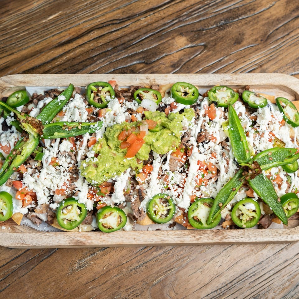 Mexican Mariachi Grill's loaded nachos with meat, cheese, guacamole, pico de gallo, and jalapeños.