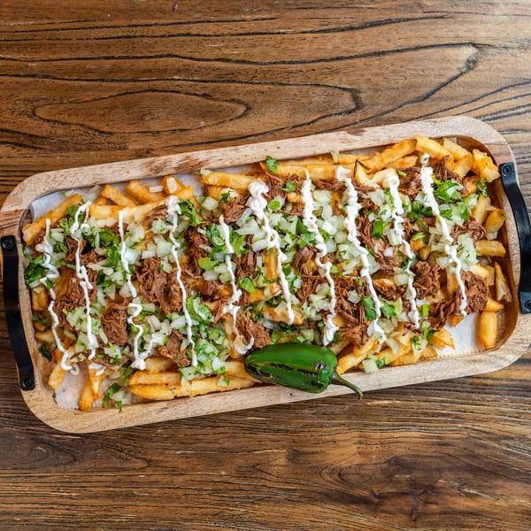 Mexican Mariachi Grill's loaded fries with shredded beef, onions, cilantro, sour cream, and a jalapeño.