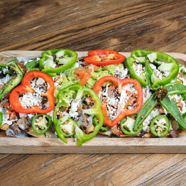 Mexican Mariachi Grill's nachos with steak, guacamole, pico de gallo, cheese, and peppers.